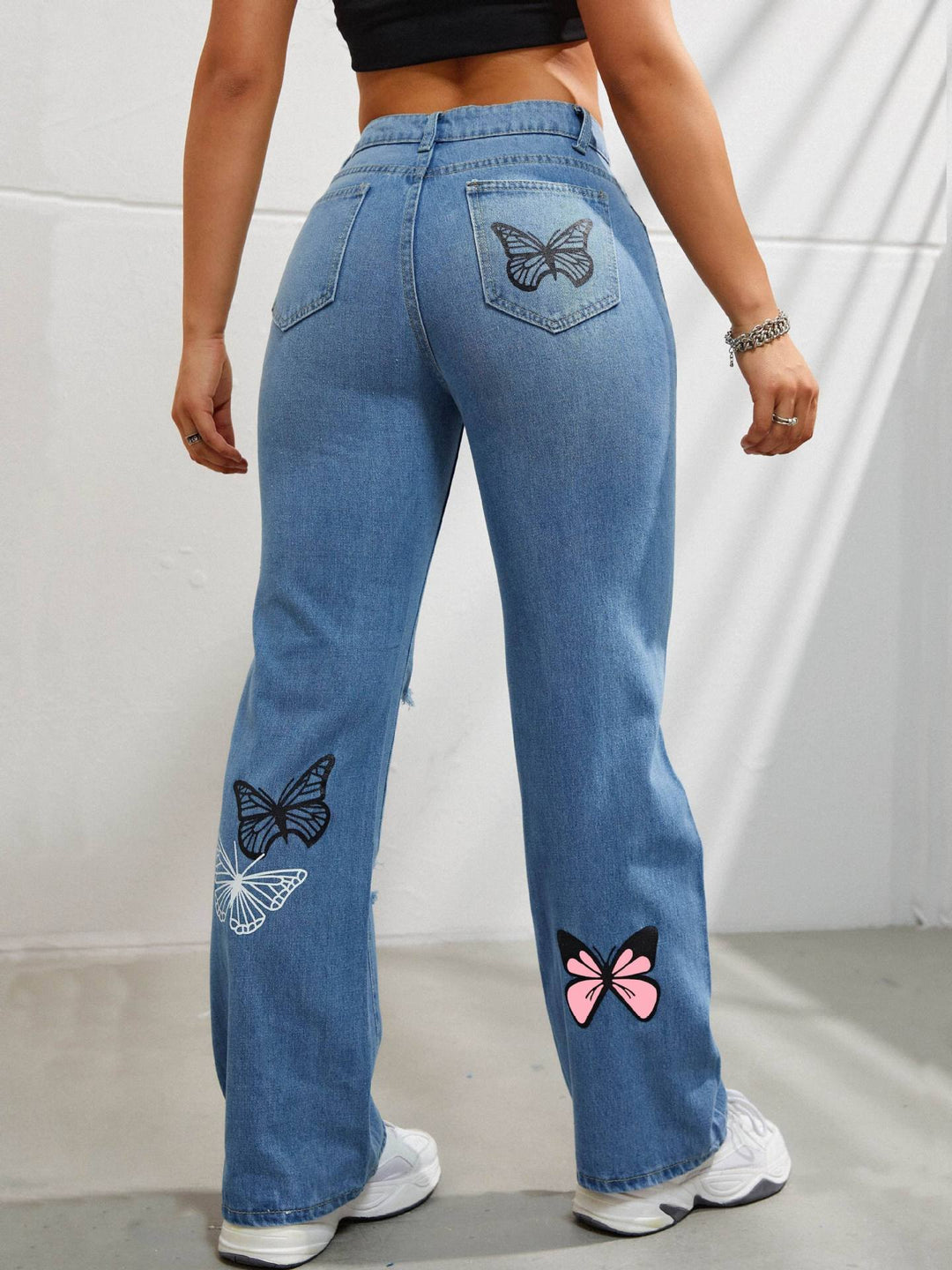 High waisted straight leg jeans with butterfly print and rips