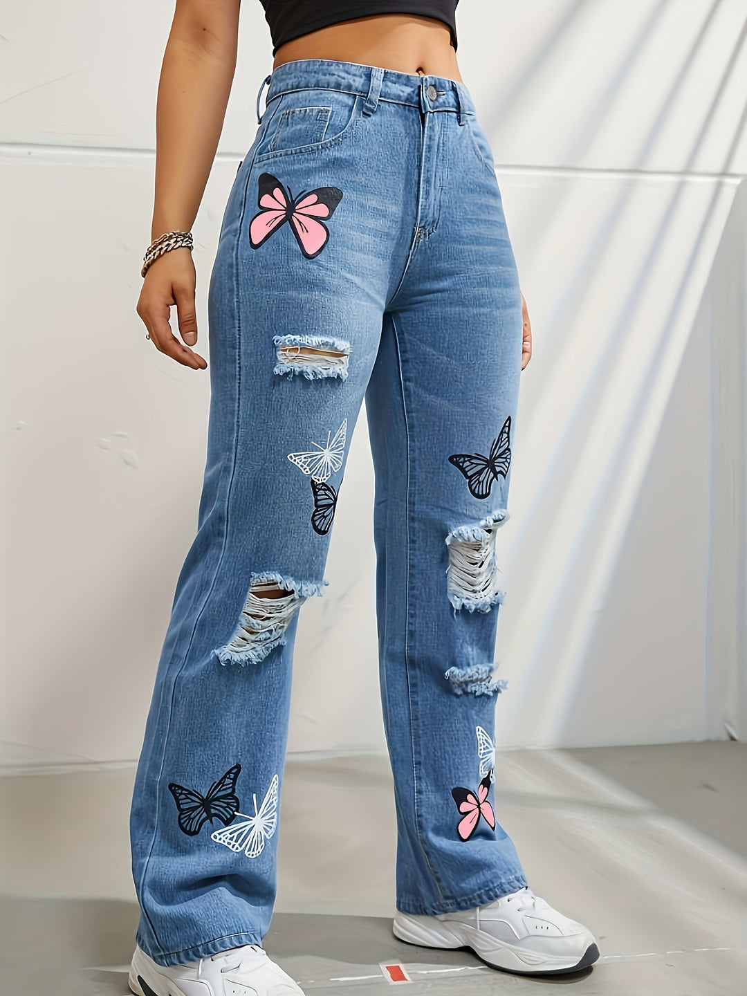 High waisted straight leg jeans with butterfly print and rips