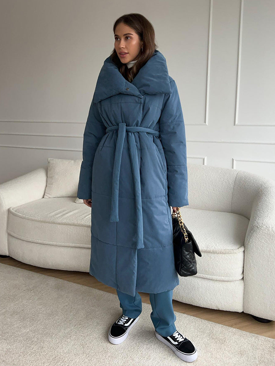 Long padded winter coat with a wide lapel and tie waist