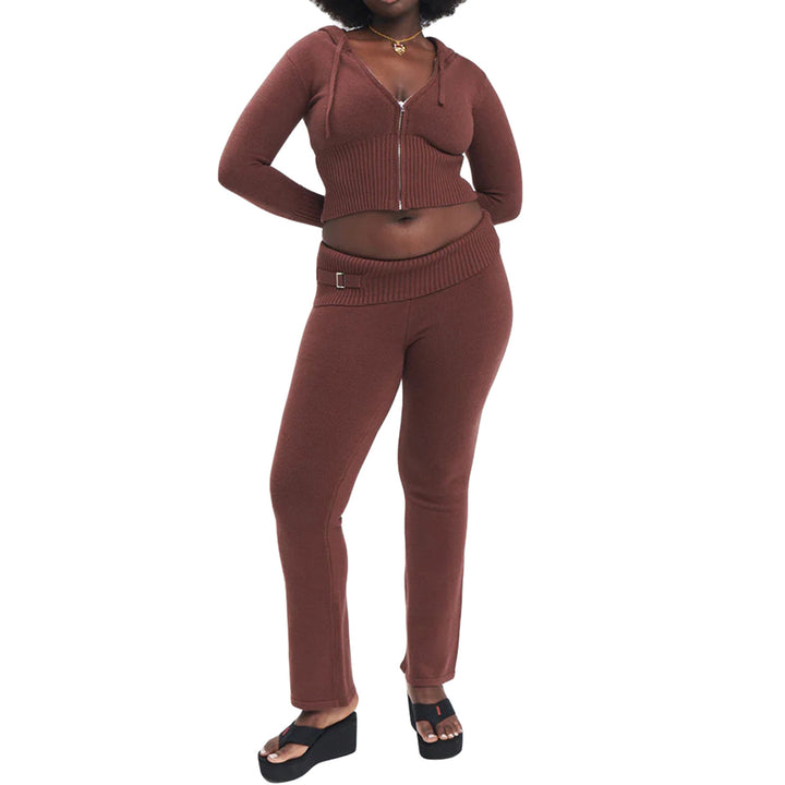 Woman in ribbed knit hoodie and flare pants set