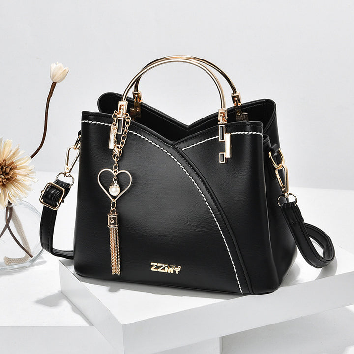 Color block handbag with heart tassel