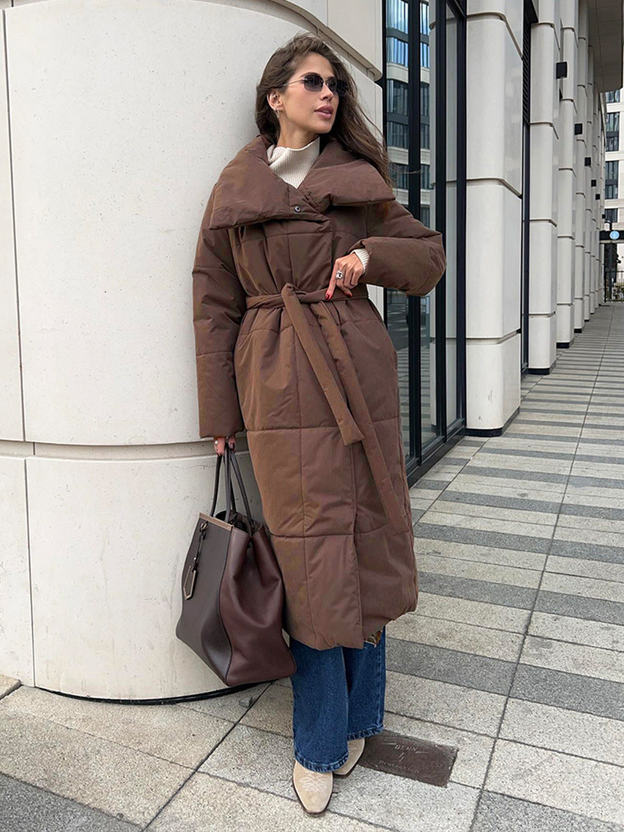 Long padded winter coat with a wide lapel and tie waist