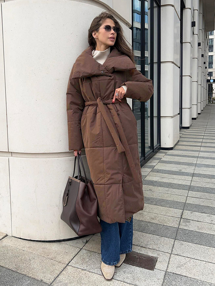 Long padded winter coat with a wide lapel and tie waist